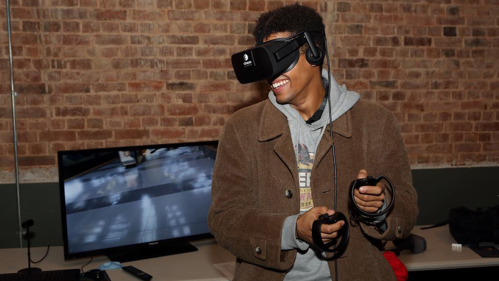 A man smiling and wearing virtual reality headset