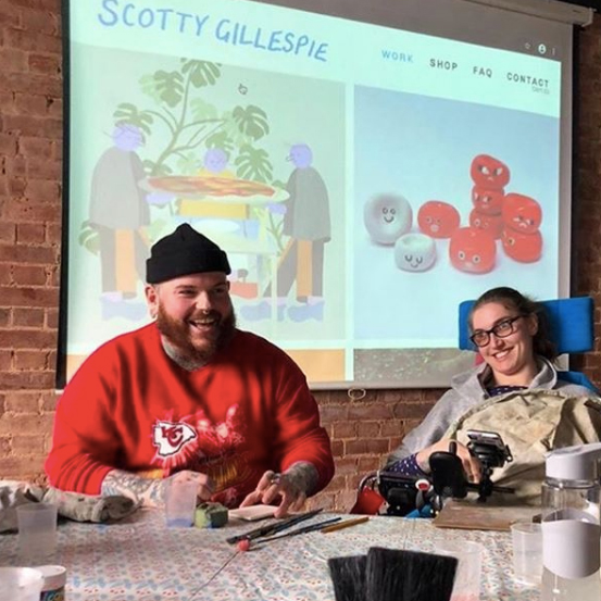 A Freefall Plus workshop with artist Scotty creating ceramic artwork with a participant in a wheelchair