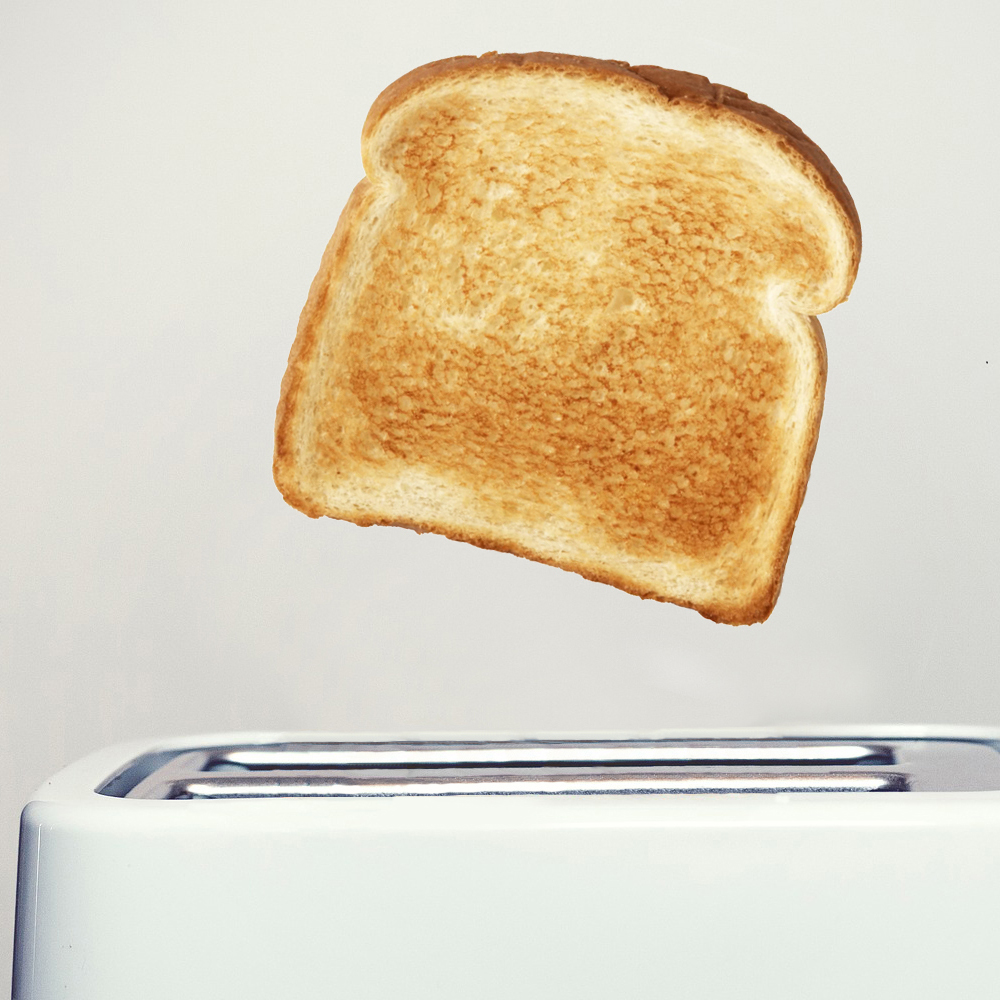 Photograph of toast popping out a toaster