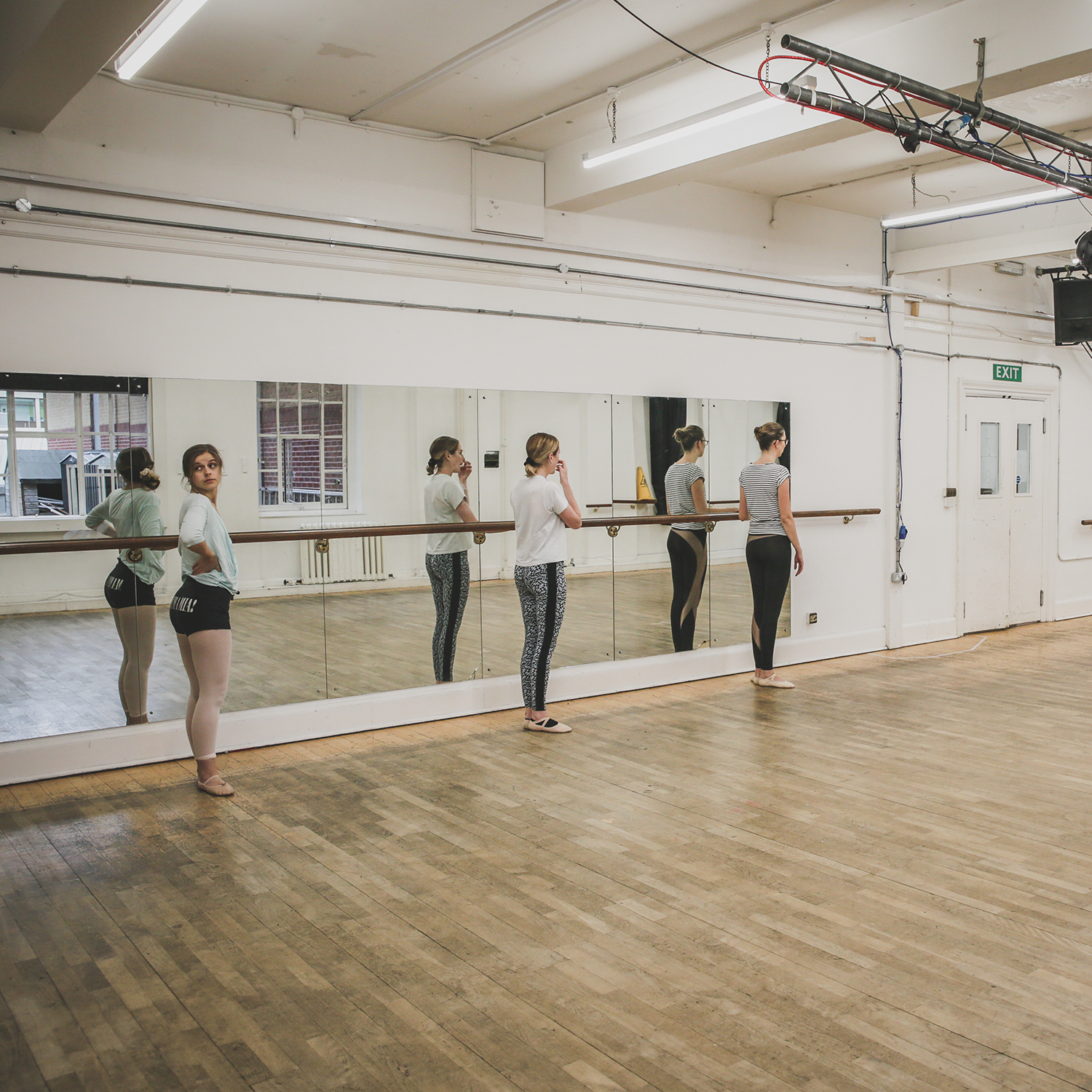 Three ladies taking part in a dance lesson.