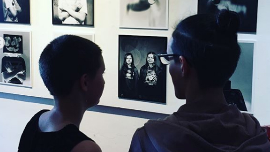 Two people looking at a photography exhibition