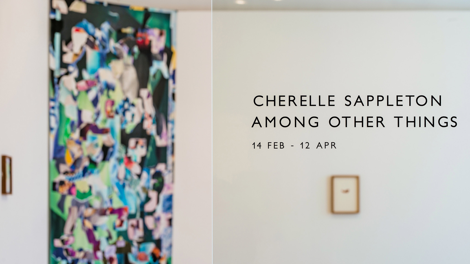 The view through the gallery doors into an exhibition of artworks by Cherelle Sappleton