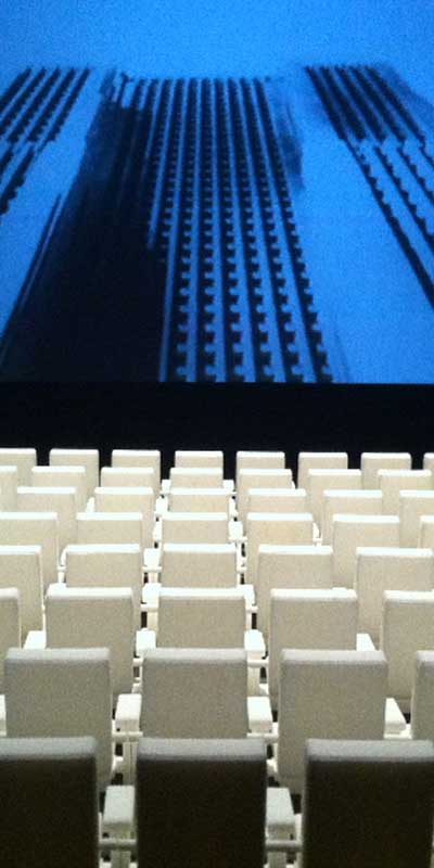 A still from Maia Conran's digital work 'Crowd' featuring rows of empty chairs.