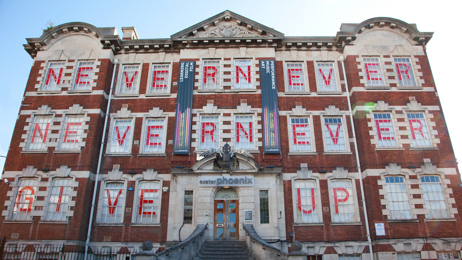 Photograph of Exeter Phoenix whose windows spell out Never Never Never Give Up