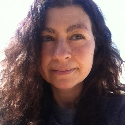 Close up photograph of filmmaker Barbara Santi who has long wavy brown hair