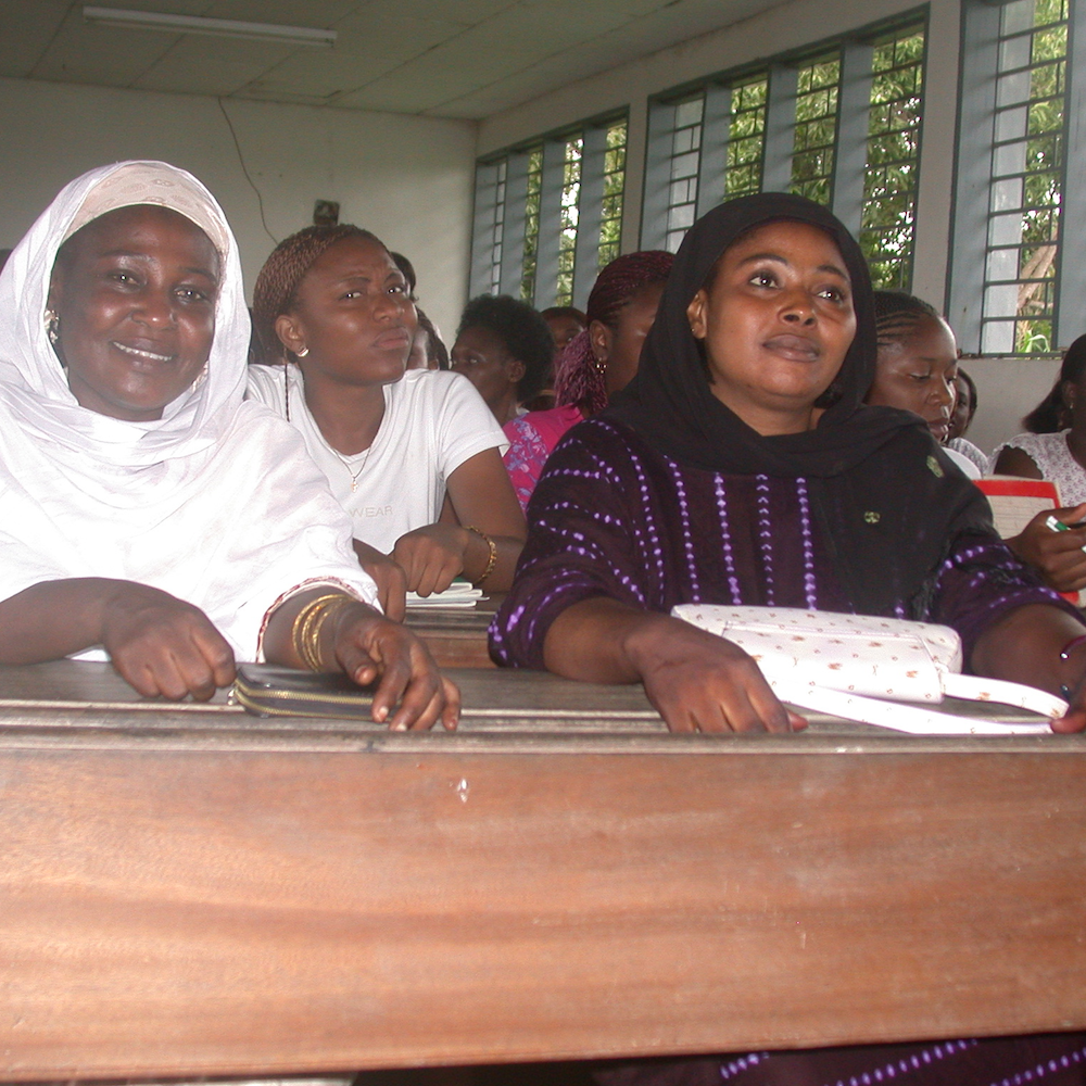 A group of women sit in a classroom