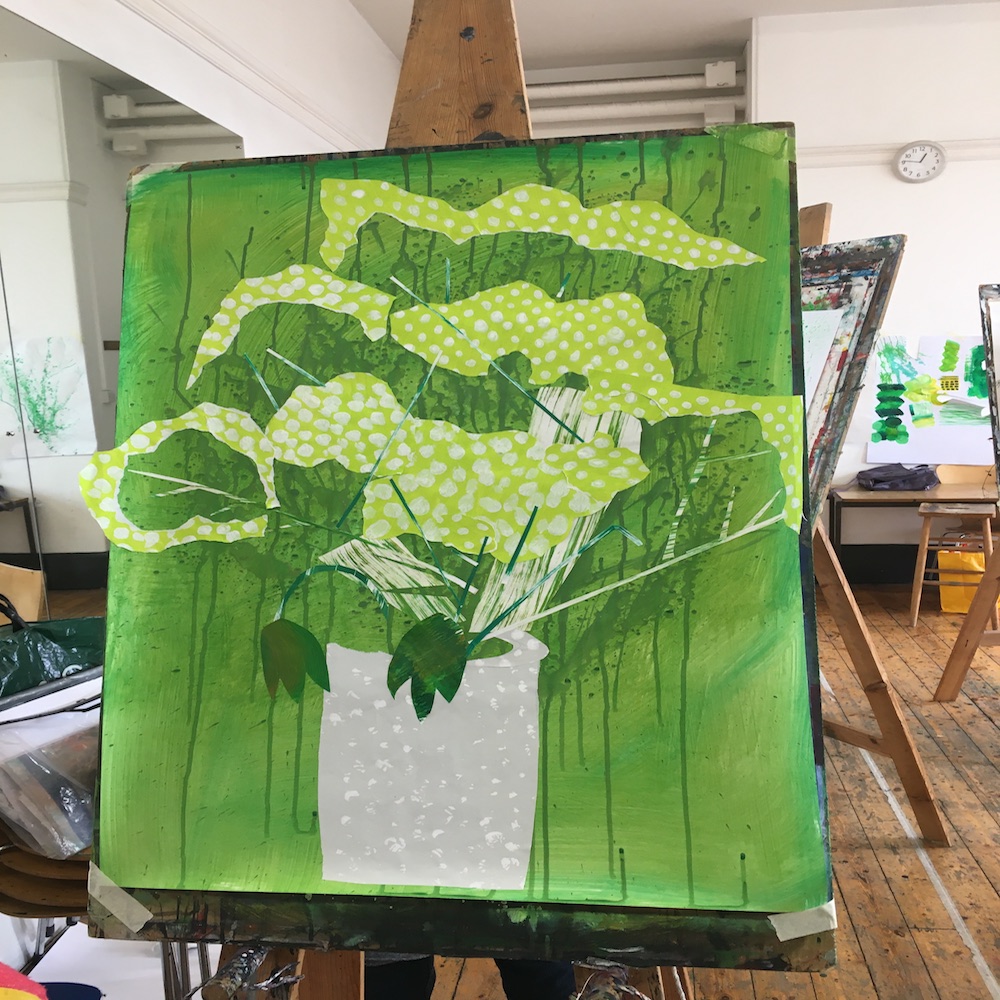 An easel with a botanical collage in green and white