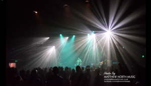 Live music photo with green and white strobe lights