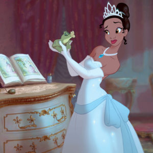 Tiana in a white sparkly dress holding a frog at arms length