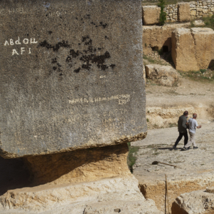 A series of large carved rocks with text carved into them