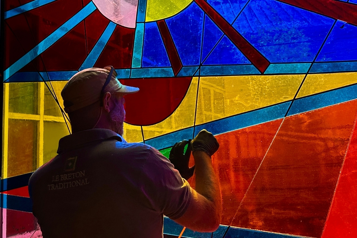 Matt Le Breton renovating the Sun and Moon Window at Exeter Phoenix, 2025