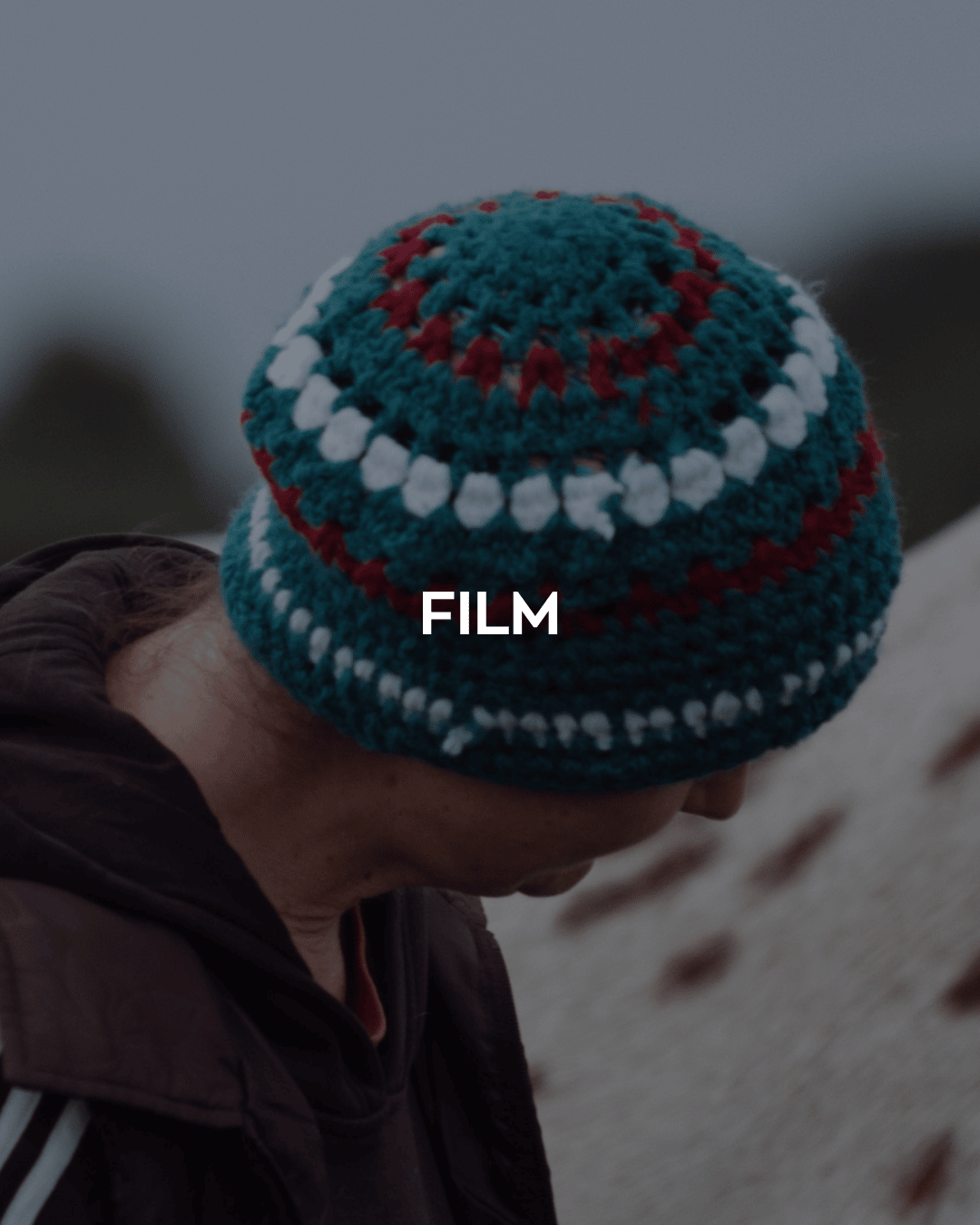 The word 'Film' over an image of someone outdoors wearing a knitted hat.