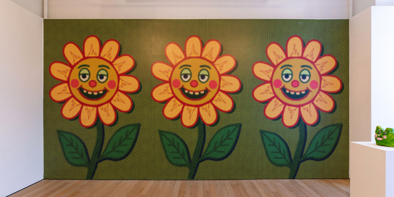 Three litho printed flowers on a gallery wall