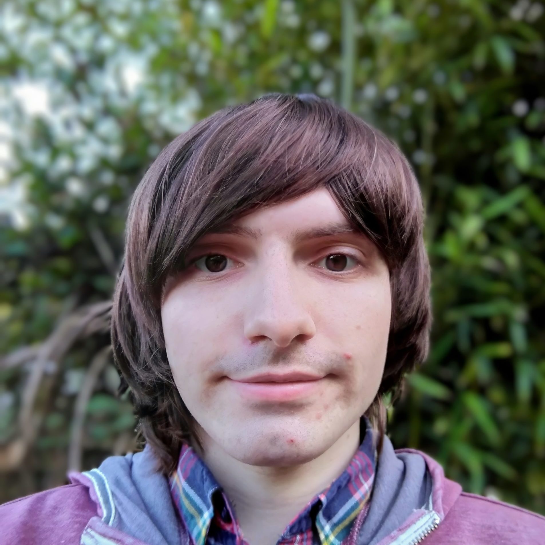 Man with long hair staring into camera.